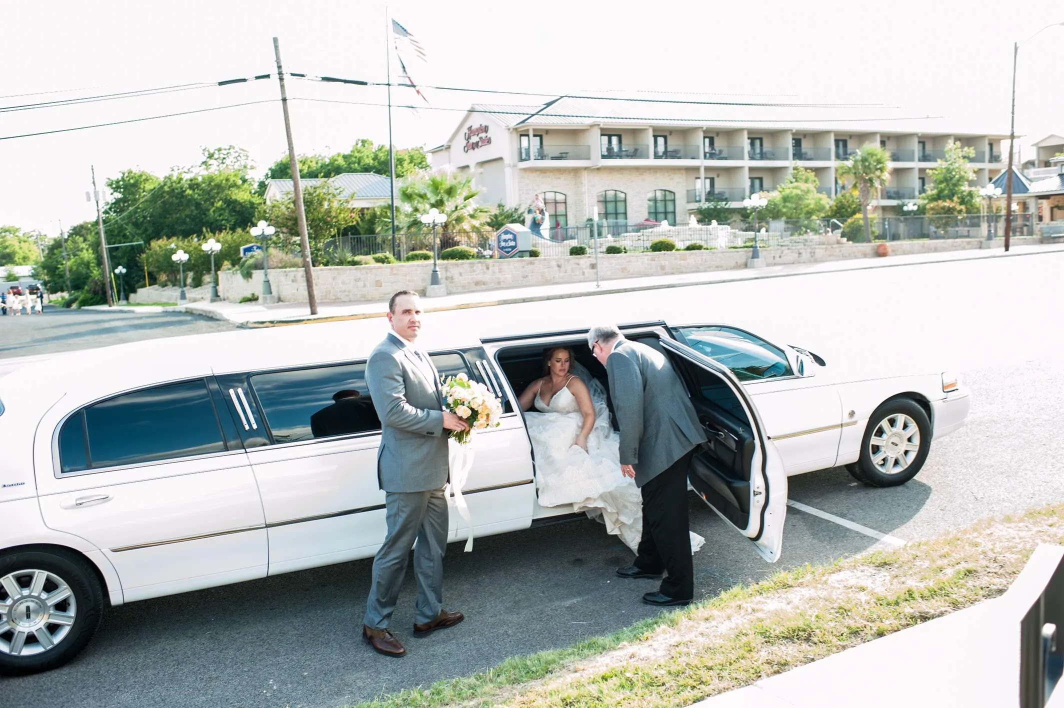 Bride and groom with the Creekstreet white stretch limo